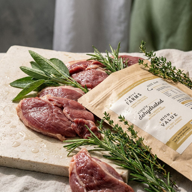 Allgood single-ingredient dog treat bag on a cutting board with meat. 