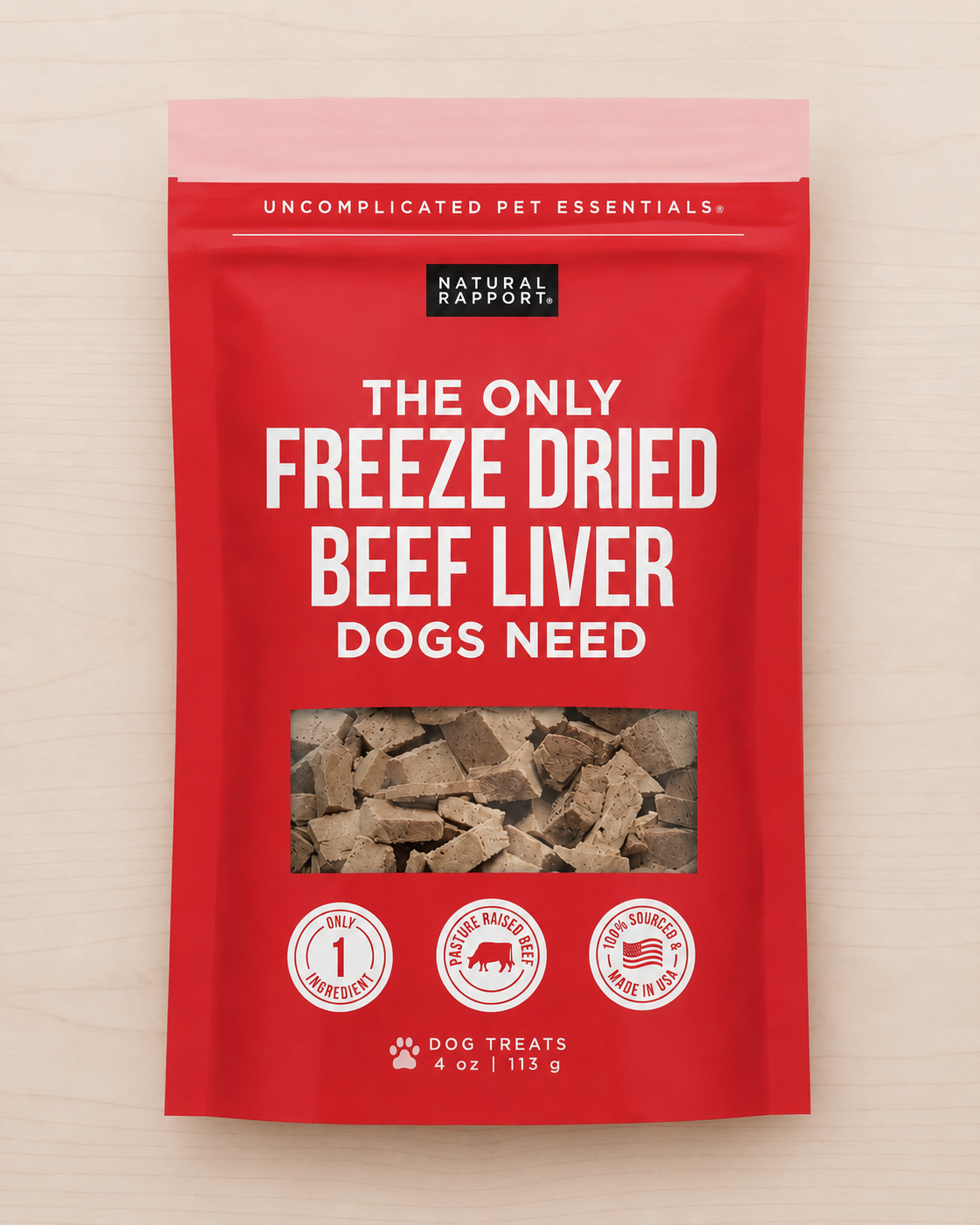 Allgood freeze dried dog treats in red bag  on a light wood background. 