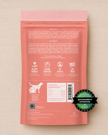 Allgood freeeze dried salmon treats,  back of a salmon-pink pet food pouch on a light wood background.
