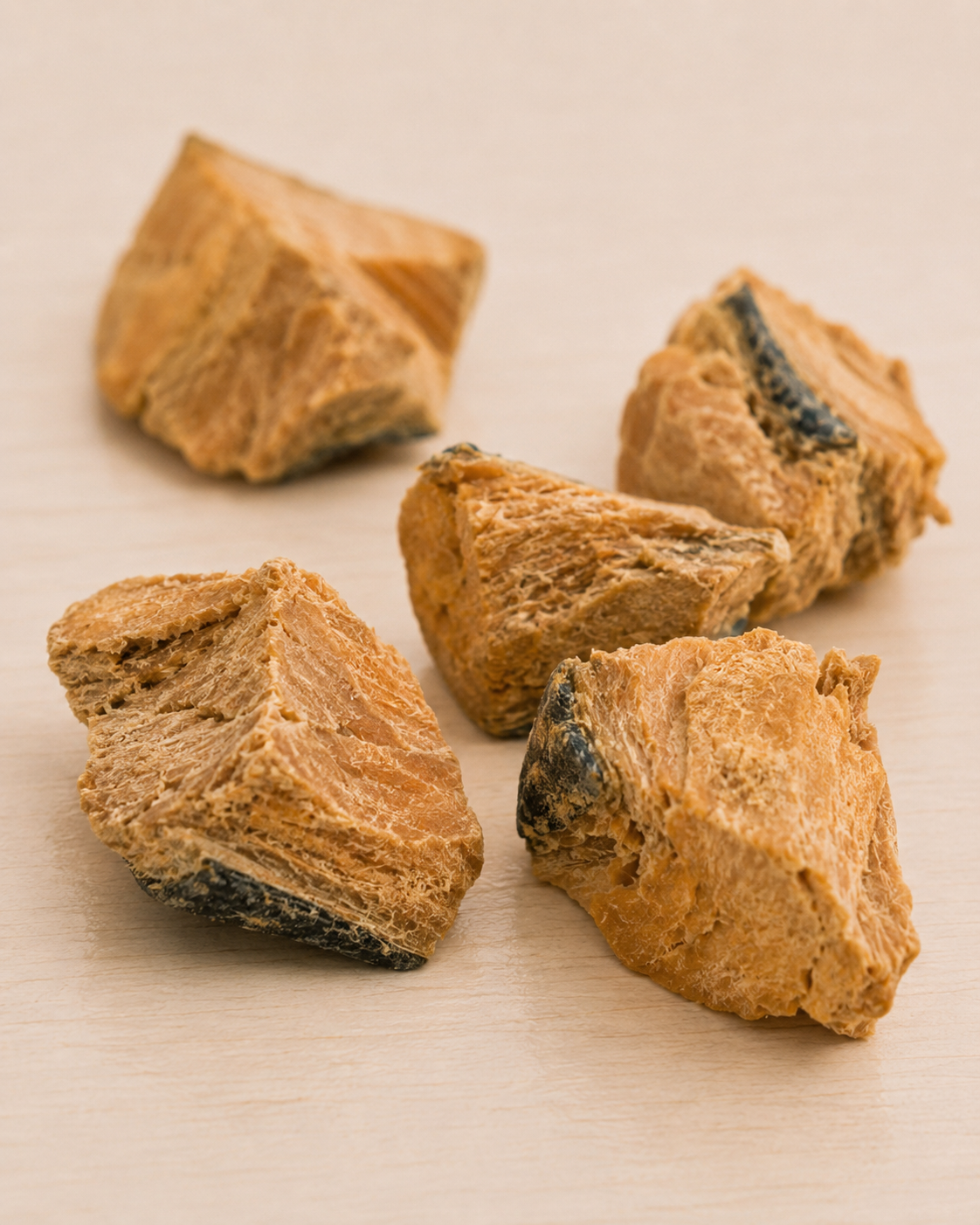 Allgood freeze dried dog treats  arranged on a light beige surface.