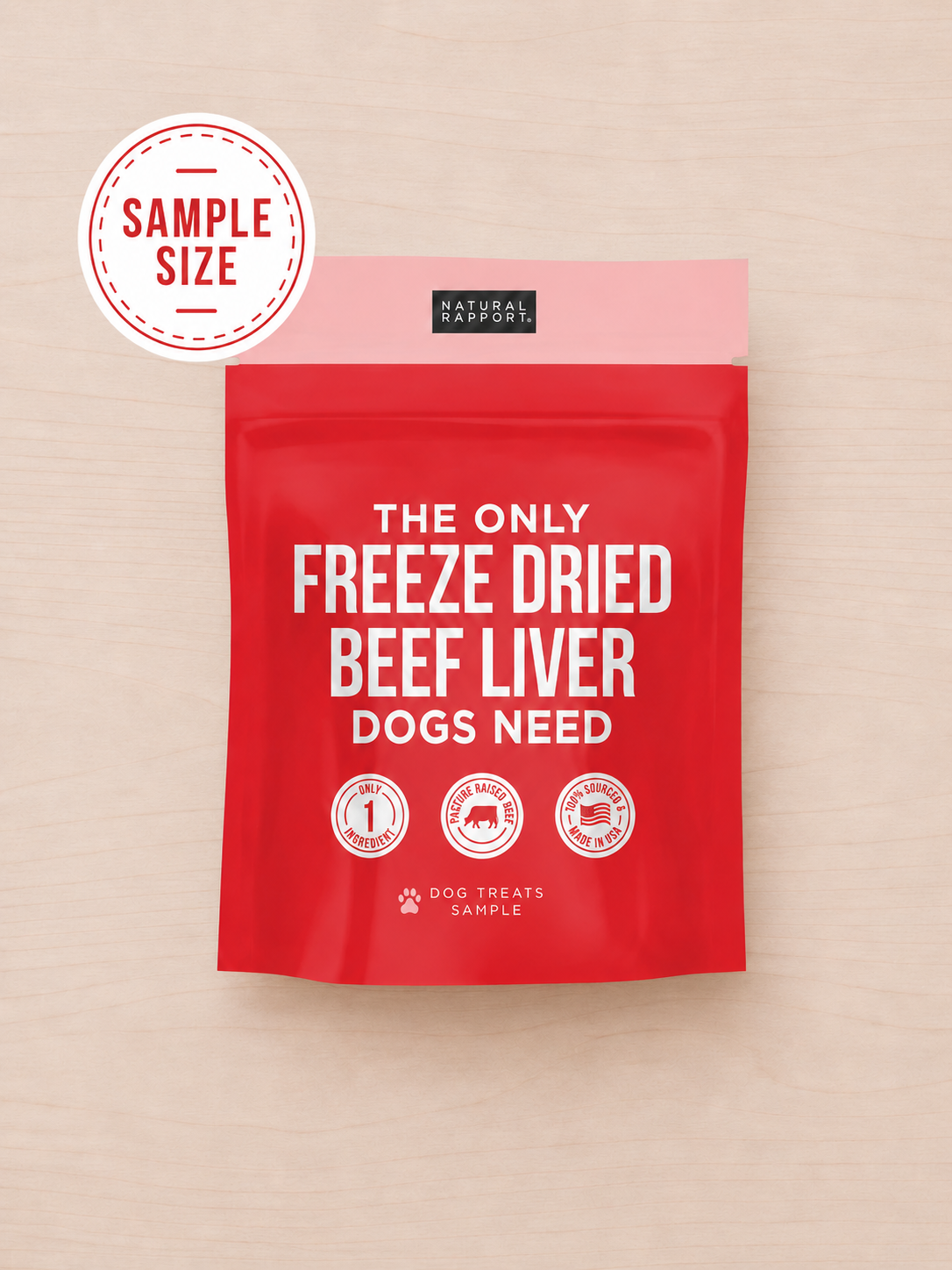 Allgood freeze dried dog treats on a red stand-up pouch on a light wood background.