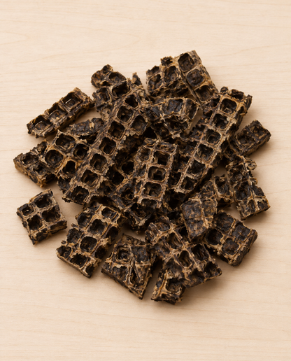Allgood beef liver dog treats arranged on a light beige wood-grain surface.