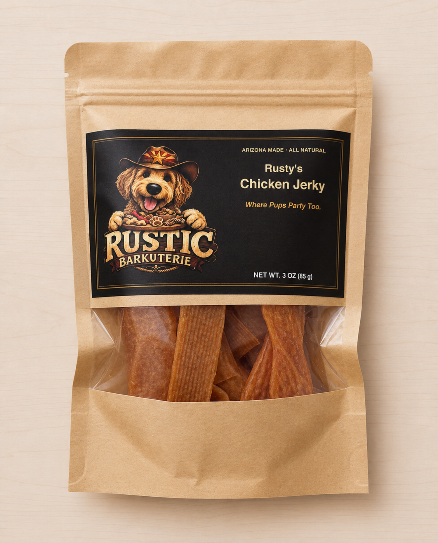 A stand-up kraft paper pouch of Rustic Barkuterie dog treats, specifically Chicken Jerky. The package features a black label with a cartoon dog wearing a cowboy hat and the brand name 'Rustic Barkuterie'.