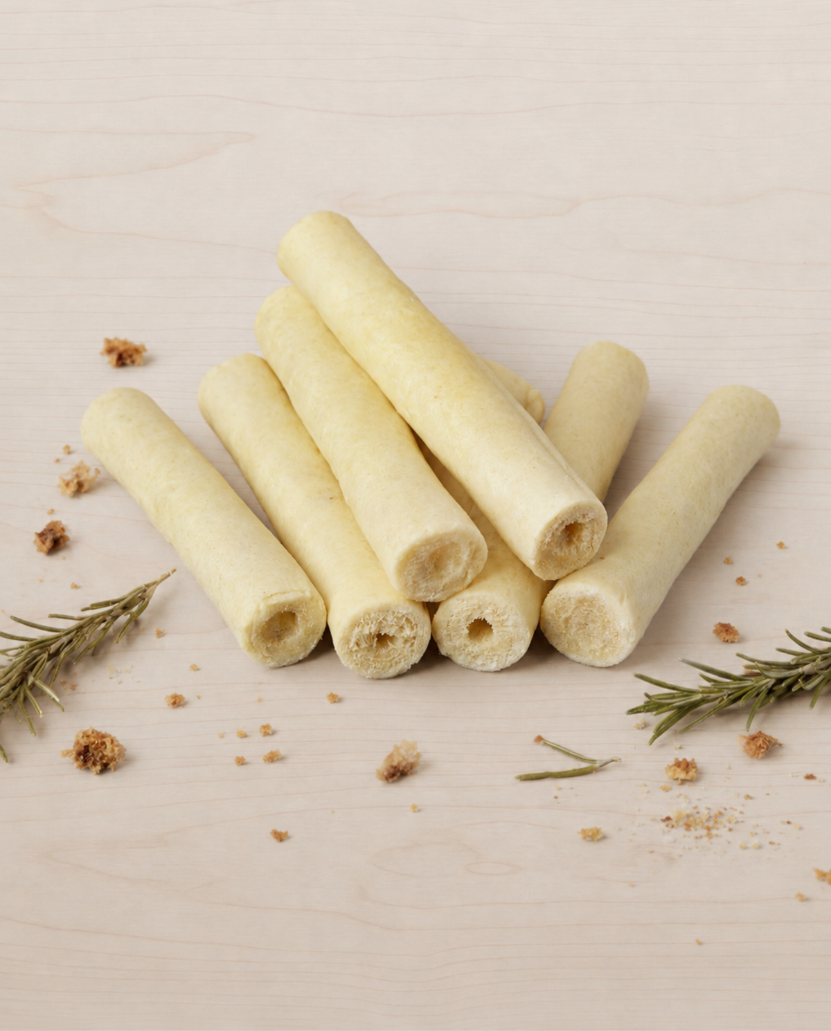 Allgood beef tails on a beige surface with rosemary leaves.