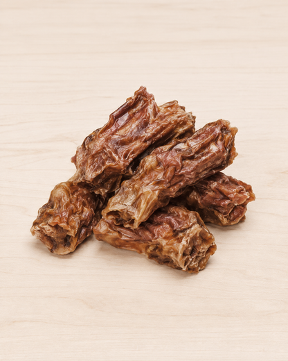 Allgood dog treat trainers, arranged on a light beige wood-grain surface.